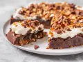 En saftig kladdkaka med fluffig grädde, kolasås och chokladbitar som topping. En dröm för alla chokladälskare!