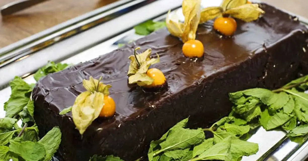 En glansig chokladtårta, perfekt för påsk, dekorerad med physalis och mynta. En härlig påsktårta choklad!