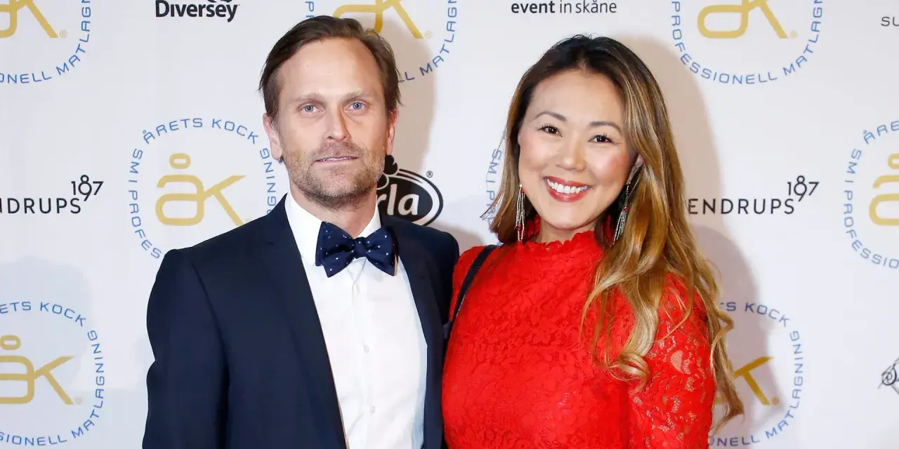 Jennie Wallden strålar i rött bredvid sin partner på en gala.