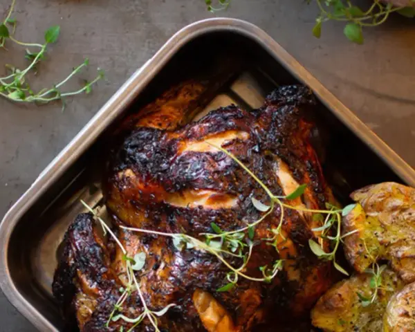 Helstekt kyckling med krispiga potatisar i ugnsform. Perfekt kyckling temperatur ger en saftig och god måltid.